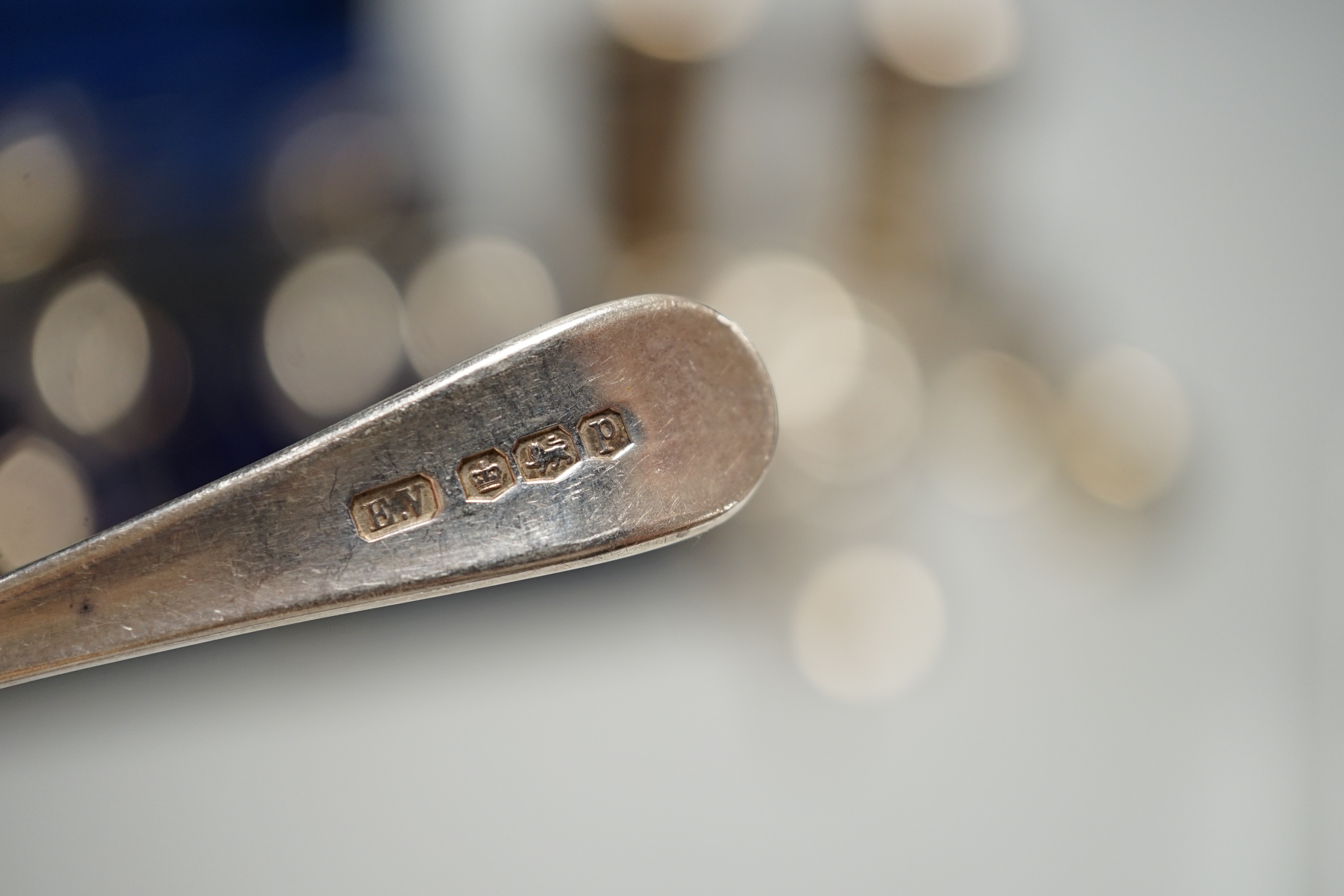 A pair of engraved white metal tumblers, stamped 'K980', four Russian 84 zolotnik spoon, a cased set of silver silver teaspoons with tongs, two silver napkin rings and other minor silver and white metal flatware.